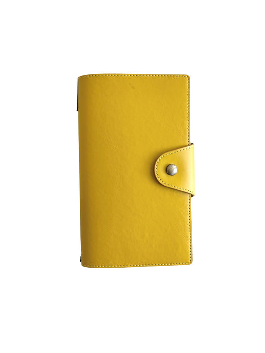 Sunshine yellow travel folio with flap and button closure, portable, interior has card slots and 2 travel notebooks