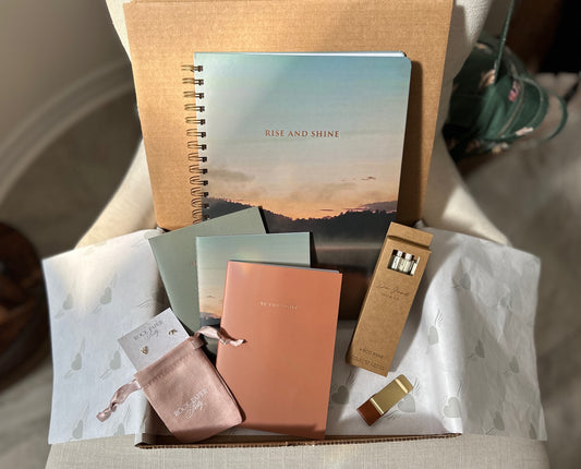 Spring stationery subscription box with Rise and Shine notebook collection, eco pens, pen clip and earrings from Canadian small business