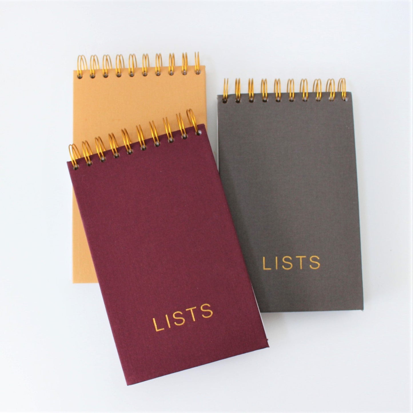 Collection of LISTS Notepads - plum, mustard and dark grey