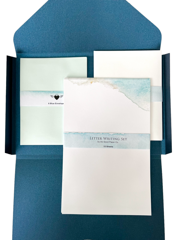Letter writing sheets on top of 6 blue envelopes and 6 white envelopes